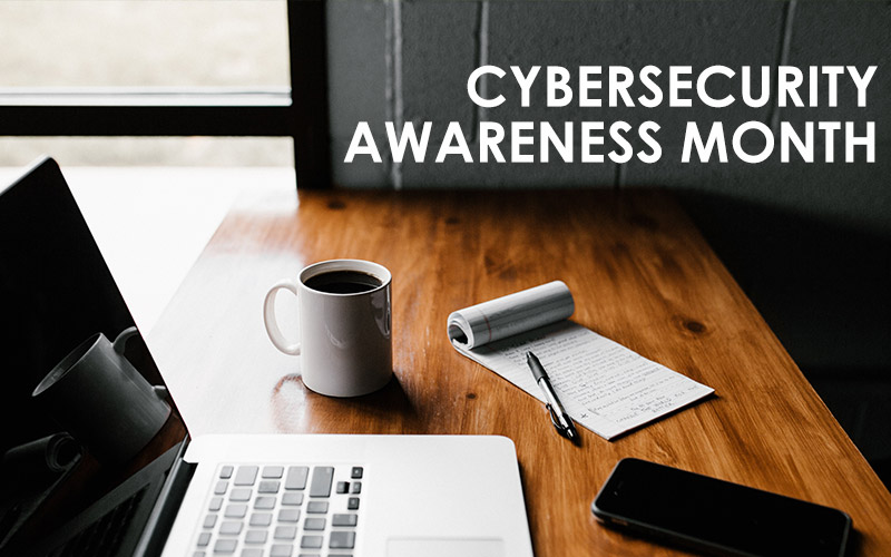 Laptop on desk with text "cyber security awareness month"
